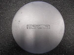 One (1) Mazda Silver Painted Center Cap B461-37-19X 6-1/8" Wide. Fixed Price $25.00.