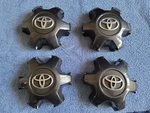 Set Of Oem 2016-2023 Toyota Tacoma Dark Charcoal Center Caps P/n 4260B-04050. Fixed Price $80.00.