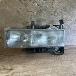 Headlight Assembly-base, Standard Cab Pickup Left Tyc 20-1669-00-9. Fixed Price $42.00.