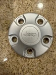 Genuine Mopar Wheel Center Cap 1AH90S4AAD. Fixed Price $19.99.