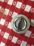 Genuine Nissan 40342-ZW10A Wheel Center Cap Ornament 04-19 Titan 05-15 Armada. Fixed Price $29.99.